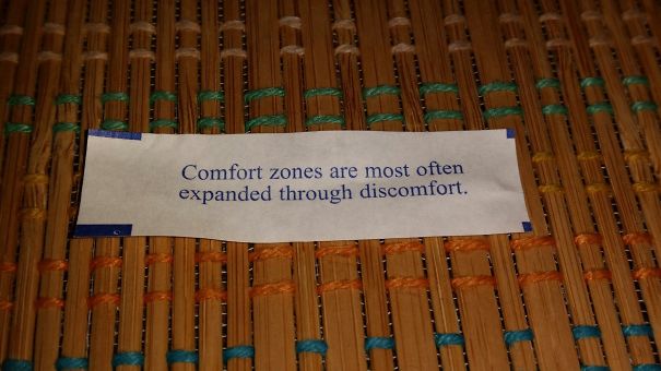 Sassy fortune cookie saying on a woven mat: "Comfort zones are most often expanded through discomfort."