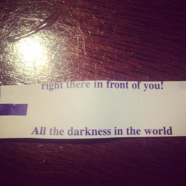 Sassy fortune cookie saying on a wooden table.