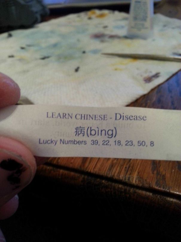 Fortune cookie paper with a sassy message teaching the Chinese word for "disease" and lucky numbers below.
