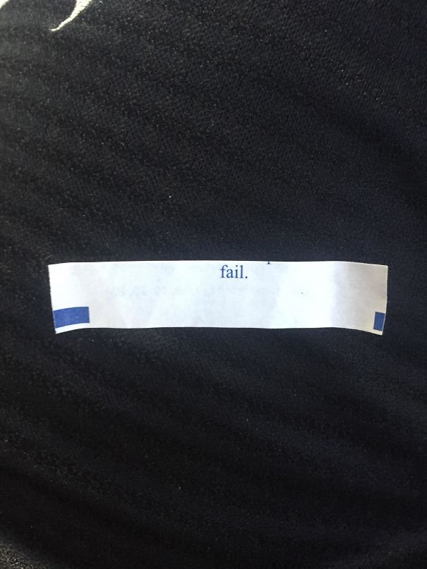 A sassy fortune cookie saying on a black background reading "fail."