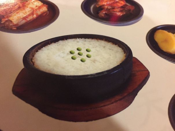 Unusual Photoshop fail showing a bowl of rice with oddly placed peas on top, highlighting hilarious editing mistakes.