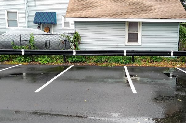 The Lines In This Parking Lot Extend Up Unto The Barrier