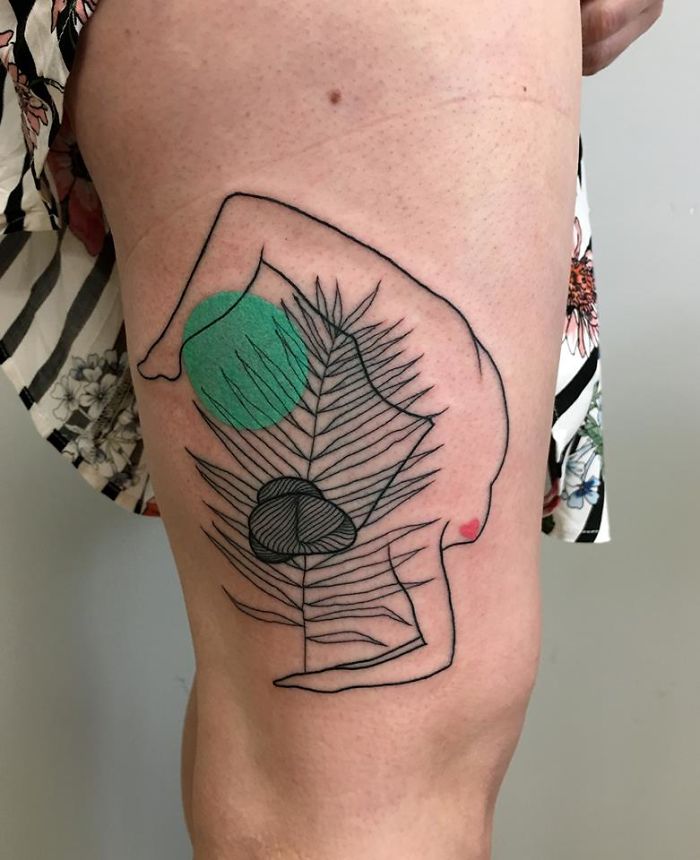 Abstract tattoo of human form entwined with nature-inspired elements on a leg.