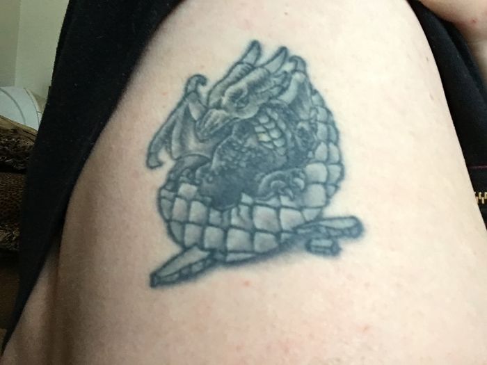 Dragon tattoo on skin, showing intricate details and shading as part of personal stories behind tattoos.