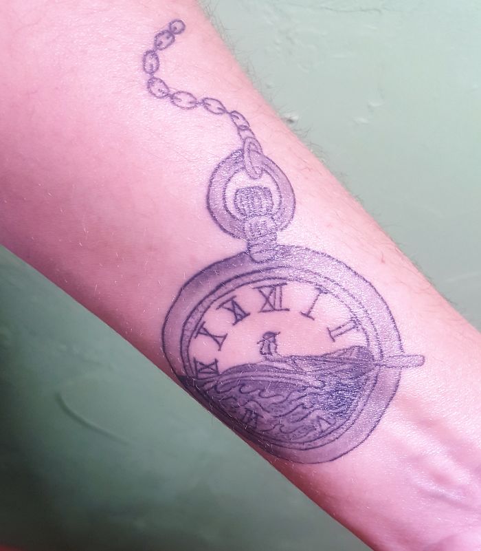 Tattoo of a pocket watch with Roman numerals and waves on the arm, illustrating personal stories and meaningful designs.