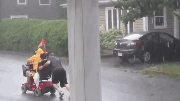 This Guy Pushes An Electric Wheelchair Uphill During A Storm