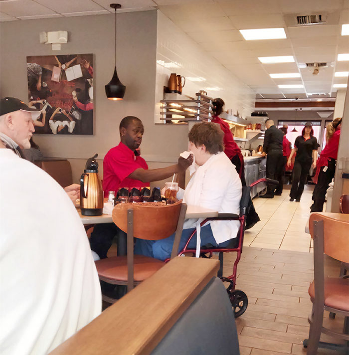 Waiter Helping To Feed Disabled Lady So Her Husband Can Finish His Meal. Good Job Good Man
