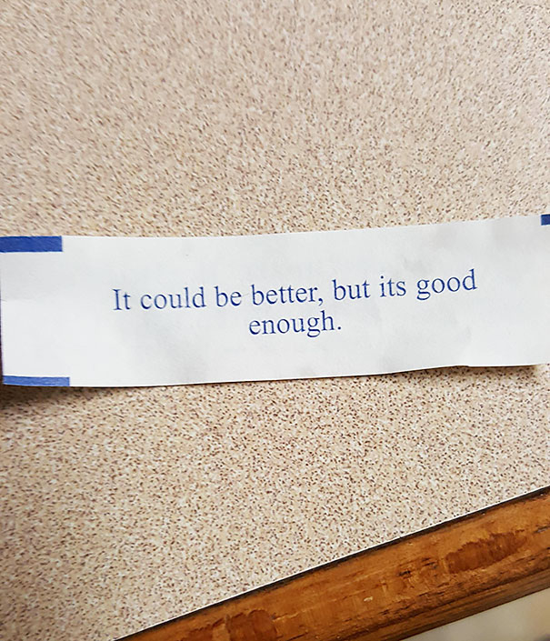 Fortune cookie with a sassy saying: "It could be better, but it's good enough," on a textured surface.