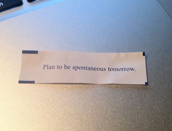 Fortune cookie saying on a table: "Plan to be spontaneous tomorrow."