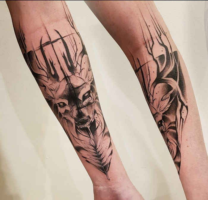 Deer and abstract designs tattooed on forearm, showcasing unique tattoo stories.