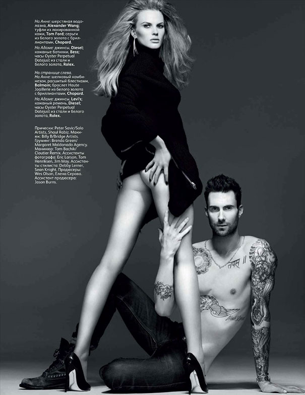 Black and white photo of a tattooed shirtless man interacting with a woman in heels and a black sweater, Photoshop fail style.