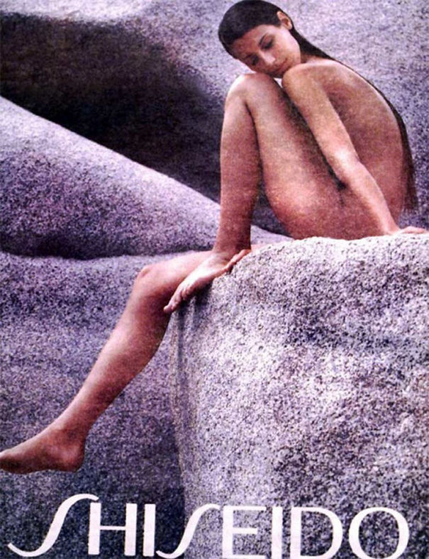 Woman with distorted and merged limbs sitting on a rock in a hilarious and disastrous Photoshop fail image.