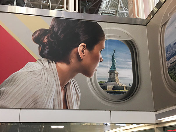 Woman looking through plane window showing Statue of Liberty, a hilarious and disastrous Photoshop fail illustration.