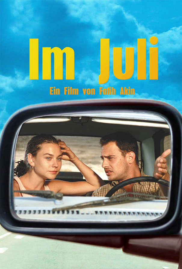 Two people inside a car, viewed through the side mirror, with a clear blue sky background, example of Photoshop fails.