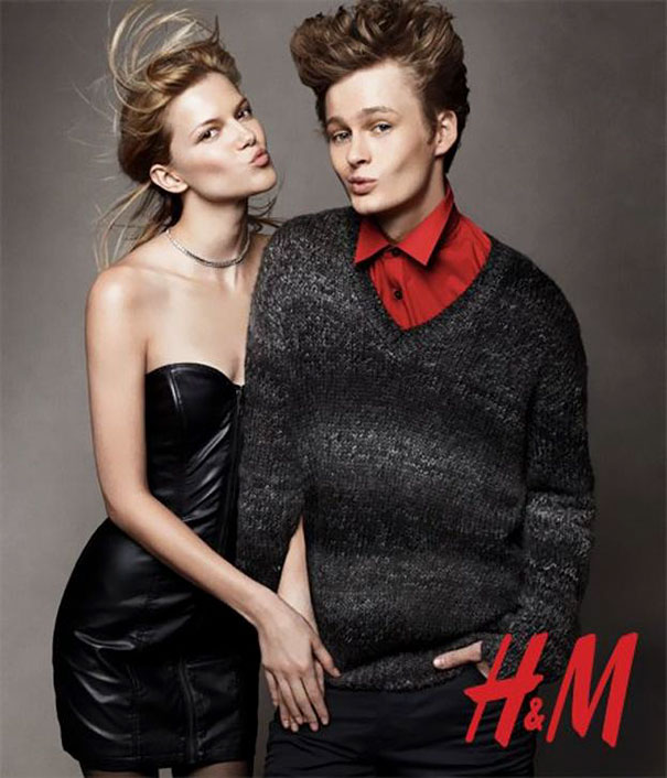 Two models posing together with a Photoshop fail causing a distorted sweater in a fashion advertisement.