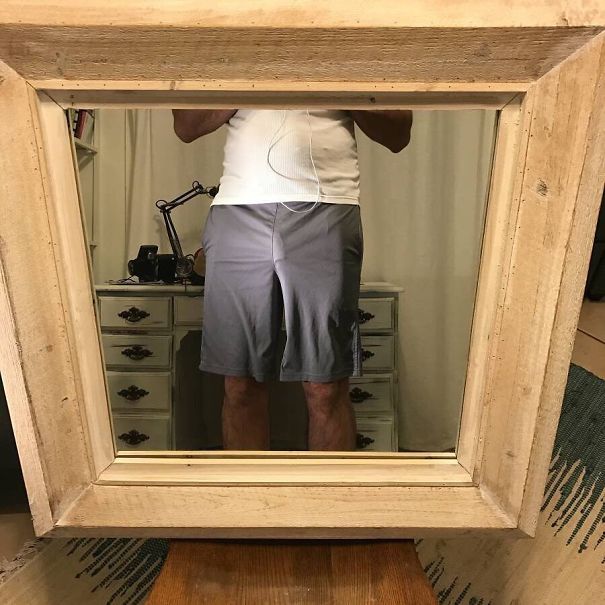 Person standing in front of a mirror they are trying to sell, with their reflection visible in the frame.