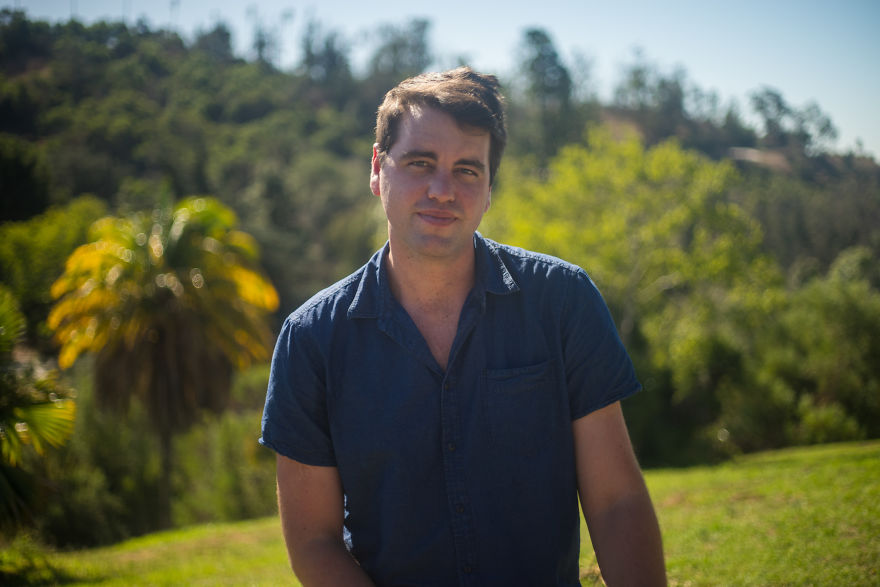 Man in a blue shirt outdoors in natural light, representing interviews with people on their birthdays concept.