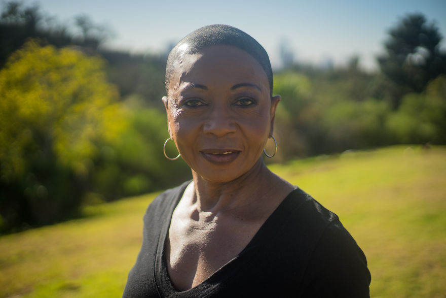Portrait of a woman outdoors, capturing a candid moment during birthday interviews with diverse people.