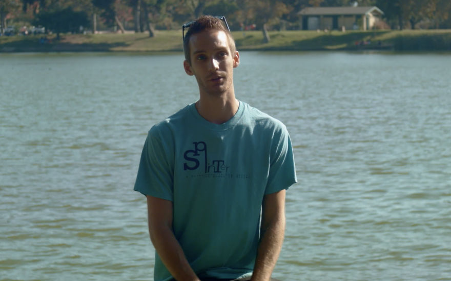 Man sitting by a lake, casually dressed, engaging in an informal conversation about interviewing people on birthdays.