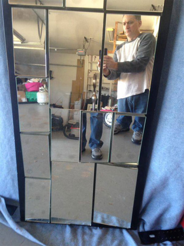 Person selling mirrors reflected in a garage, showcasing their unique segmented design.