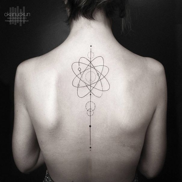 Geometric spine tattoo featuring abstract and symmetrical designs.