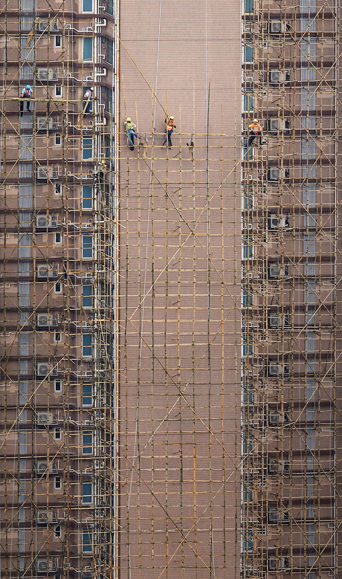 "Bamboo Weavers," Workers Are Setting Up The Bamboo Scaffolding That Will Be Used For The Building's Facade Restoration