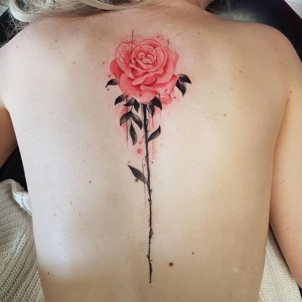Pink rose spine tattoo design on back.