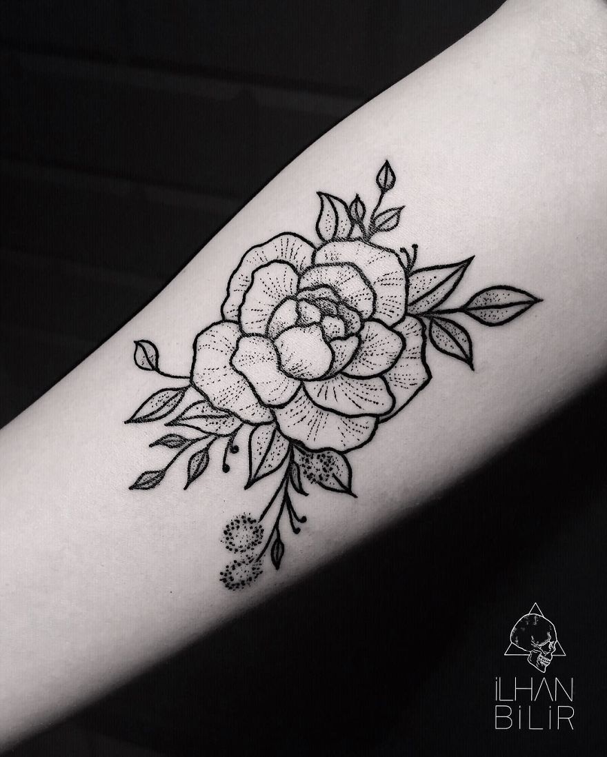 Tattoo featuring dotwork and contrast by Ilhan Bilir, showcasing a floral design with simplicity on an arm.