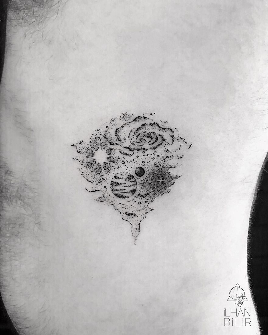 Dotwork tattoo by Ilhan Bilir featuring a cosmic design with planets and stars, showcasing simplicity and contrast.
