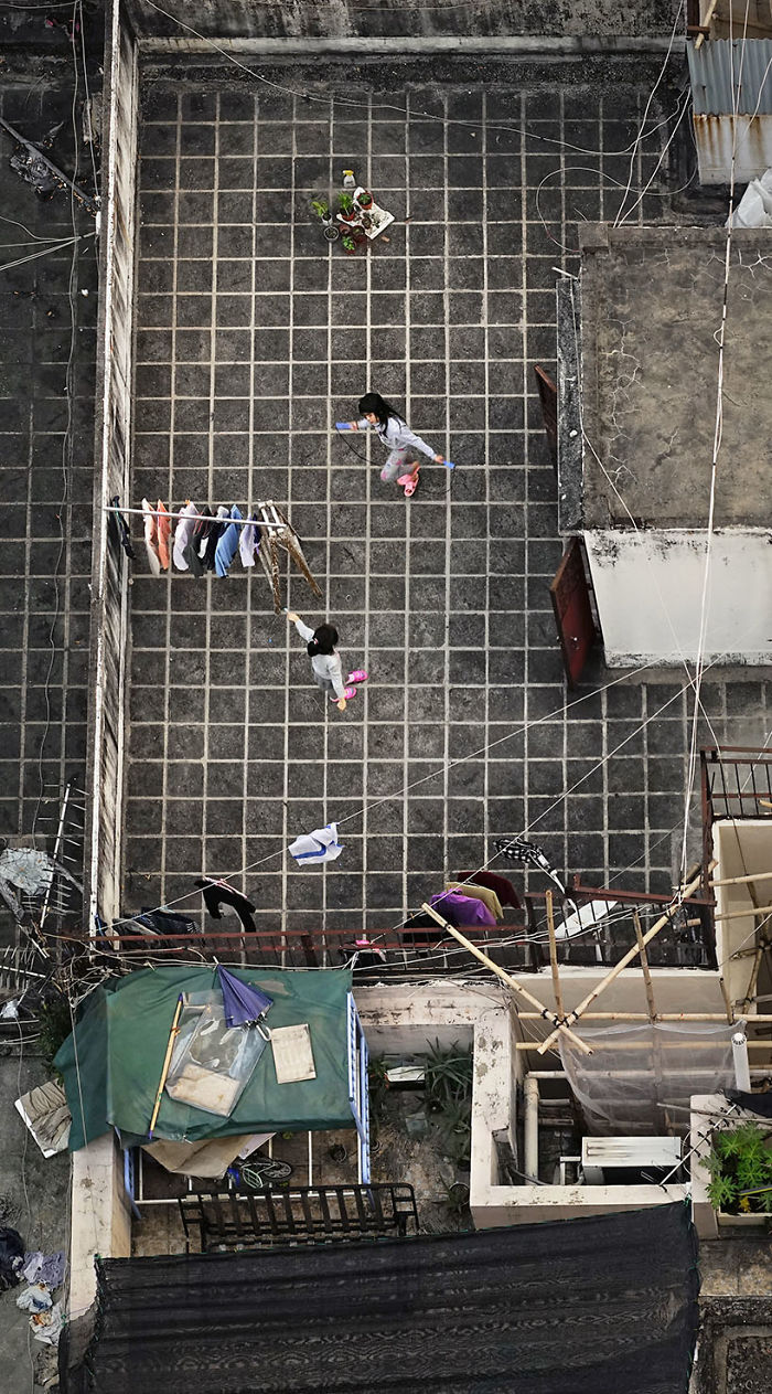 "Life In Pink And Grey," Two Little Girls Are Playing With Skipping Rope On The Rooftop