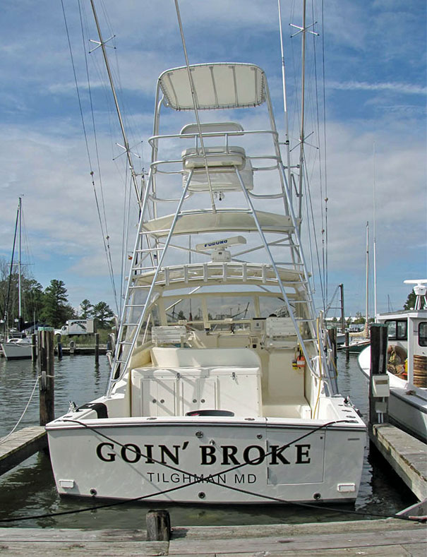 Funny named white boat docked 
