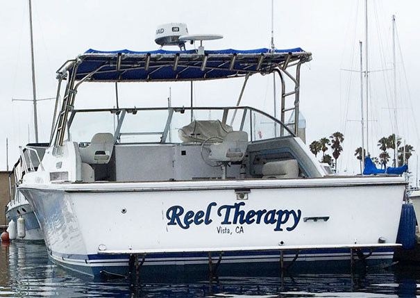 Funny named white and blue boat docked 
