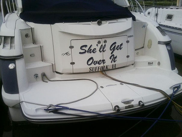 Funny named white boat docked 
