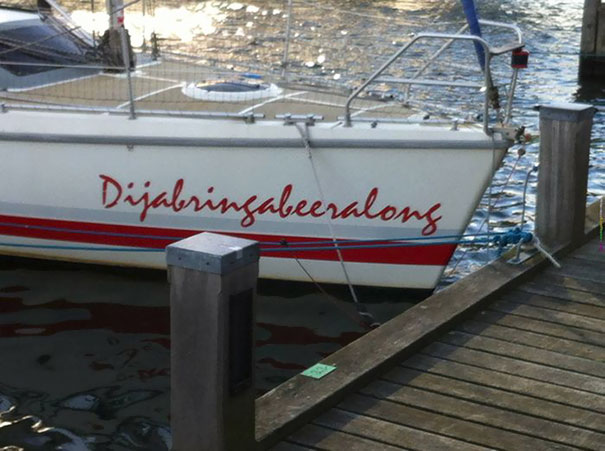 Funny white named boat docked 