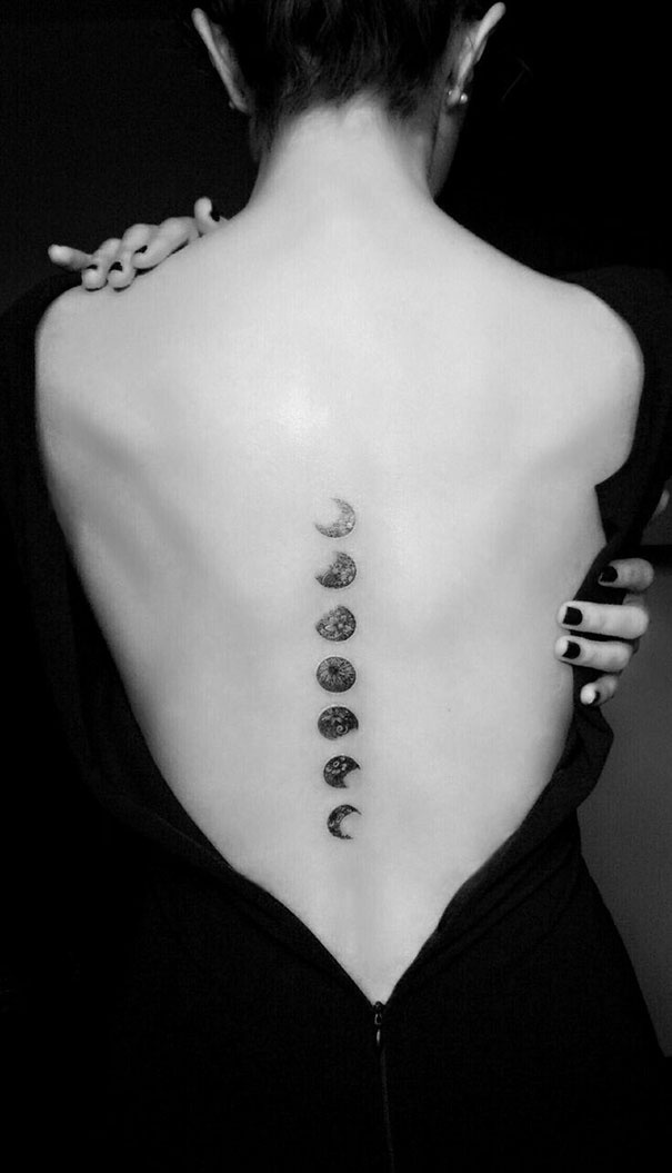 Moon phase spine tattoo design on a woman's back, showcasing intricate detail in black ink.