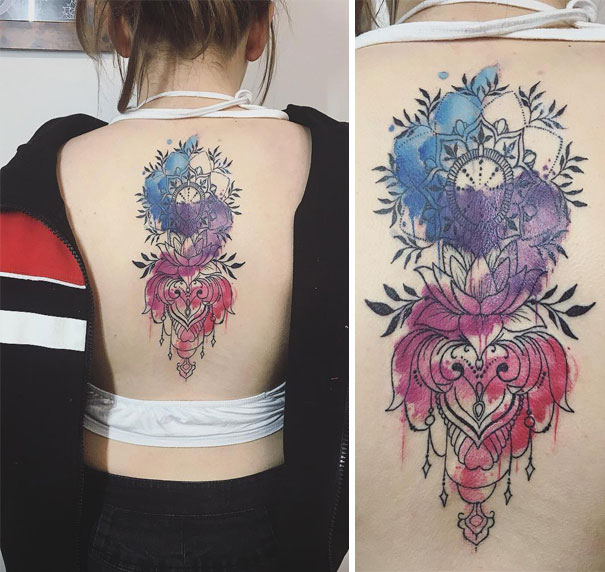 Colorful floral spine tattoo with intricate mandala design on woman's back.