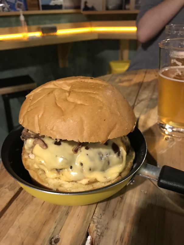 Huge Burger Served On A Small Frying Pan. Why? Just So You Can Make A Mess On The Table, Which Is A Barrel