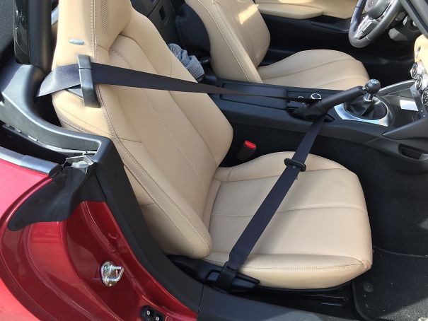 I Was Just De-Tangling The Passenger Belt From The Driver’s Side When It Snapped Out Of My Hand And Lodged Itself Under The Parking Brake. Neither Brake Nor Belt Would Budge. Had To Call For A Tow