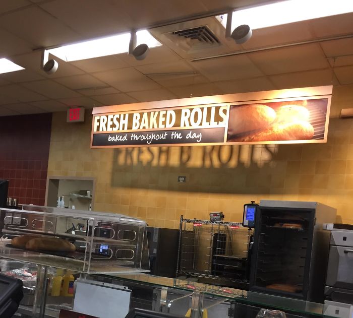 This Sign Says "Fresh Baked Rolls" But Its Shadow Says "Fresh B Rolls"
