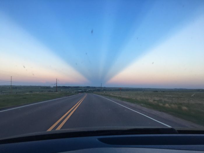 The Shadow Of A Mountain At Sunset Silhouettes Against The Sky