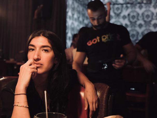 I Took A Picture Of My Roommate And The Waiter Looks Like He Has A Really Long Arm