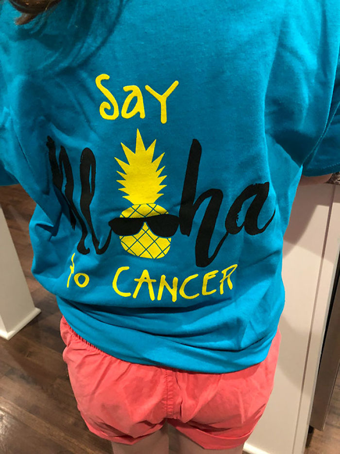 Epic clothing disaster with a confusing shirt design: "Say Aloha No Cancer" featuring a pineapple.