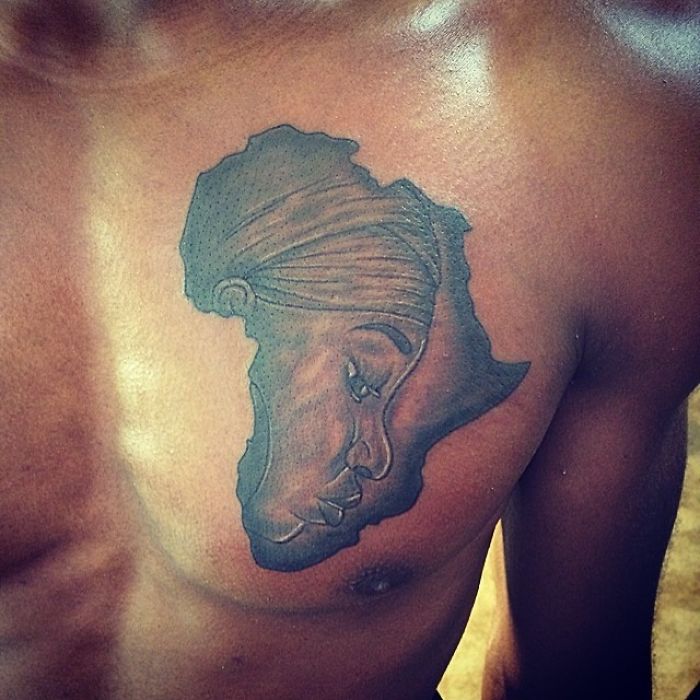 Tattoo artist skillfully interprets a client's sketch, creating a detailed tattoo on a man's chest.