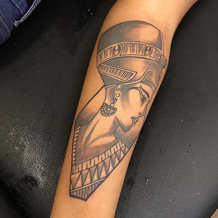 Tattoo artist's skill showcased with a detailed Egyptian queen tattoo on an arm, capturing a client's wish from a rough sketch.
