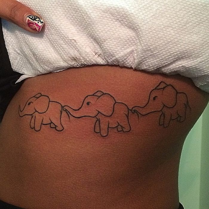 Tattoo artist skillfully interprets client's sketch; three elephants tattooed on hip.