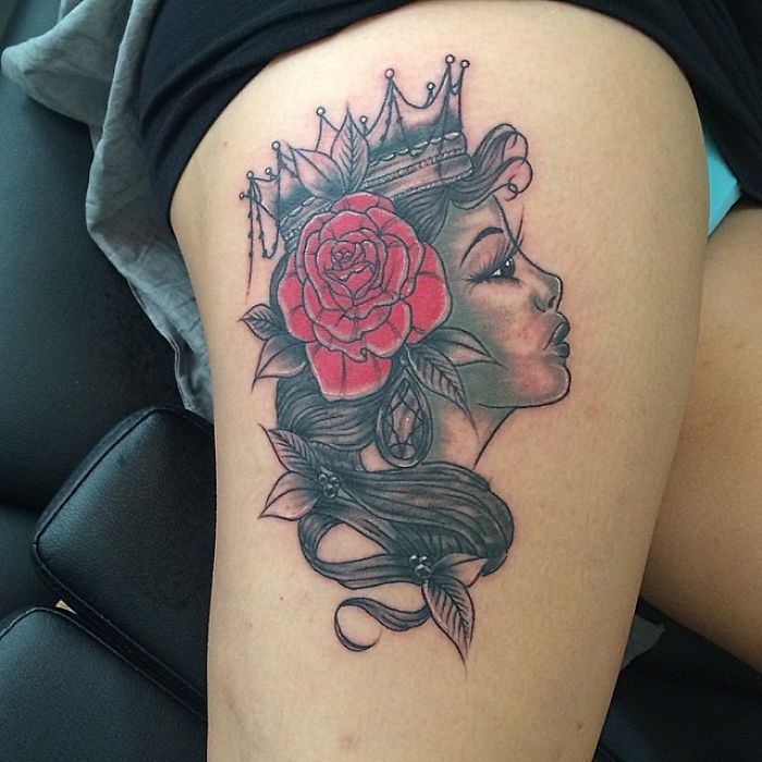 Tattoo of a crowned woman with a rose in her hair, showcasing an artist's skill in understanding a client's wish.
