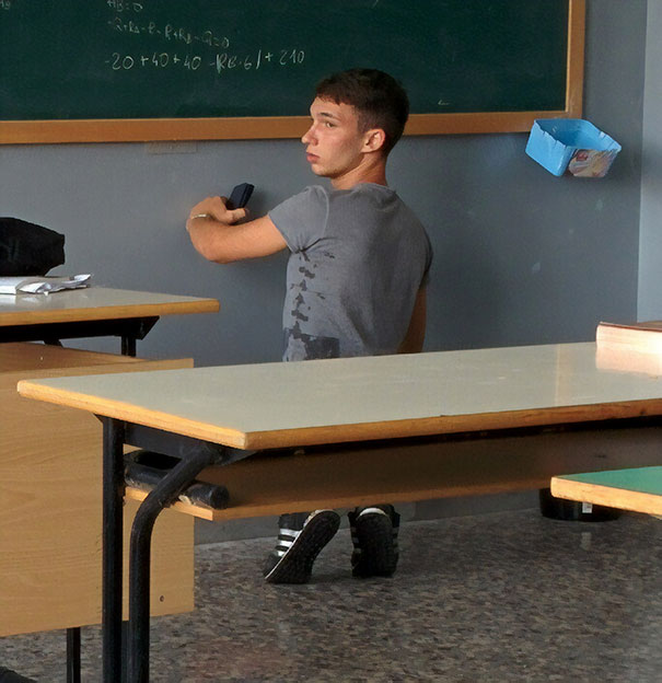 Small Man Erasing A Blackboard On His Toes