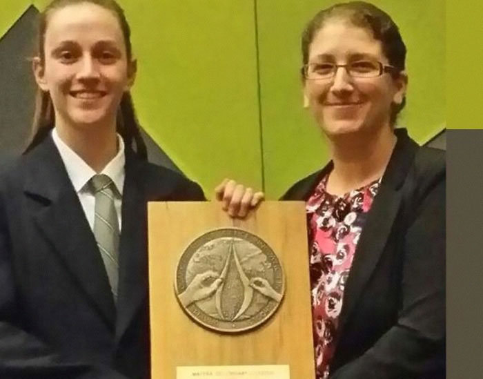 I Present To You The "Graeme Clark Oration Award For Science Innovation". It's Supposed To Be Two Hands Peeling Away Layers Of The Earth