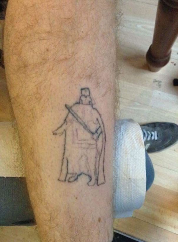 Crude leg tattoo fail resembling a thin outline of a cloaked character on a hairy leg, creating a humorous cringe-worthy moment.