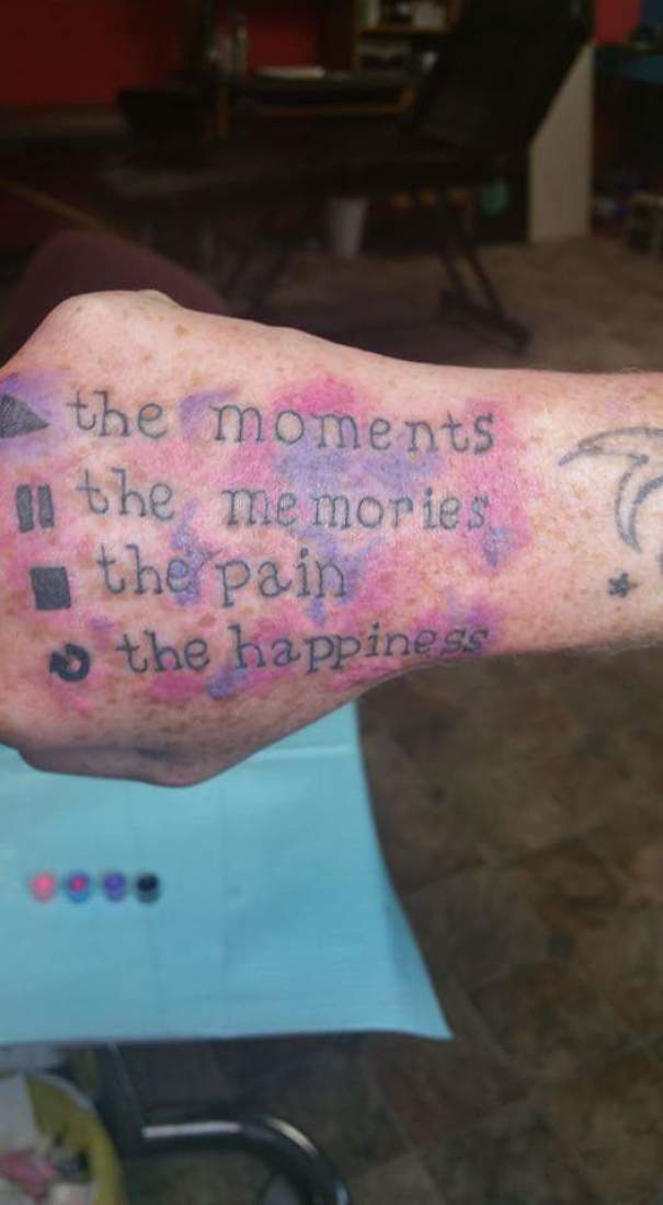 Hand tattoo with text errors highlighted, showcasing a tattoo fail with smudges in a humorous way.